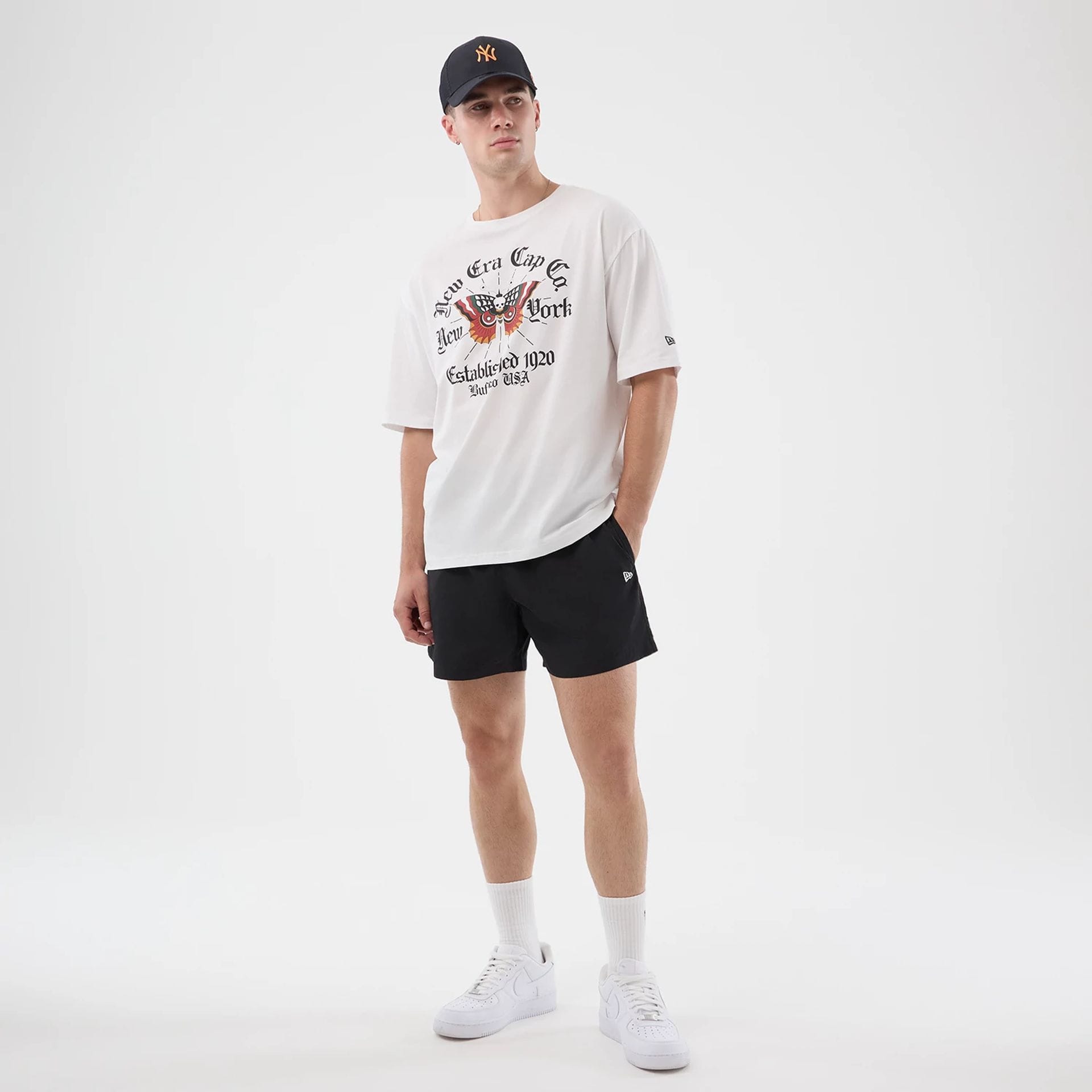 The model is wearing this New Era Death Moth Graphic Oversized T-Shirt in white. 8