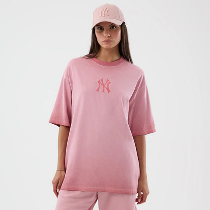 New Era New York Yankees MLB Washed Logo Pastel Pink T-Shirt, front view on a model styled with a matching pastel pink cap, featuring the raised New York Yankees logo on the chest and a loose, casual fit that falls below the hips.