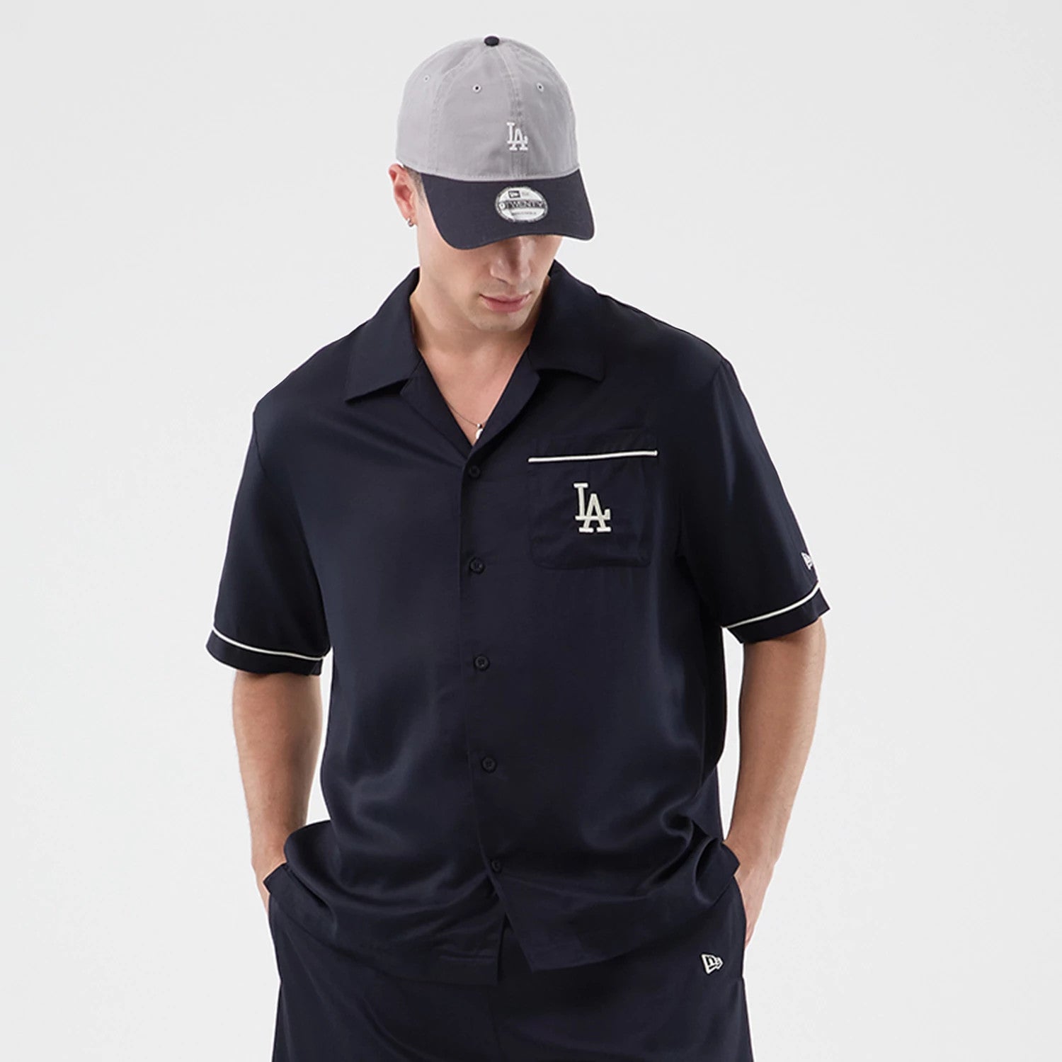 The model is wearing this MLB Graphic Revere LA Dodgers Short Sleeve Shirt in navy. 3