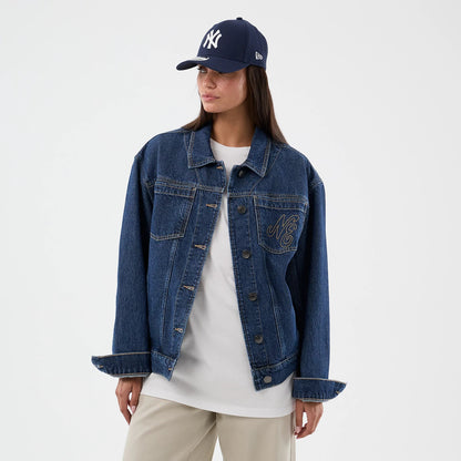 The model is wearing this New Era Script Denim Jacket in dark blue. 4