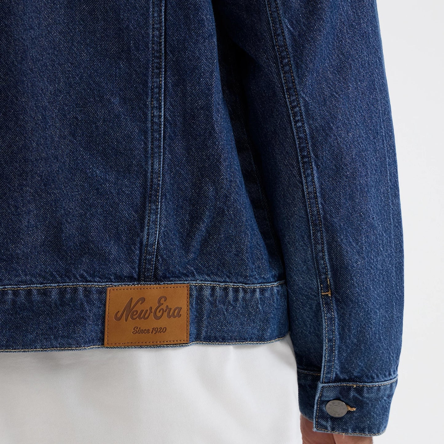 The model is wearing this New Era Script Denim Jacket in dark blue. 6