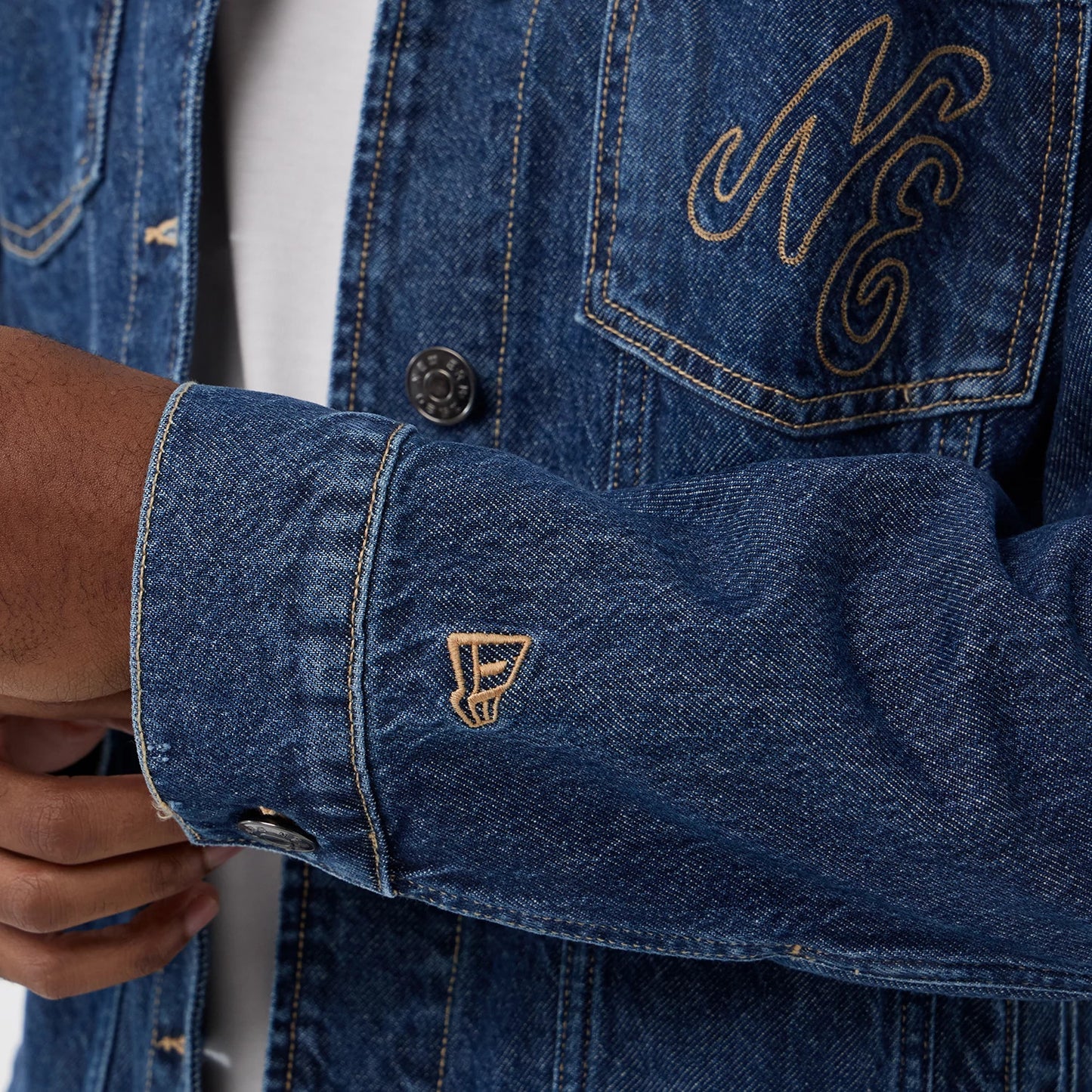The model is wearing this New Era Script Denim Jacket in dark blue. 7