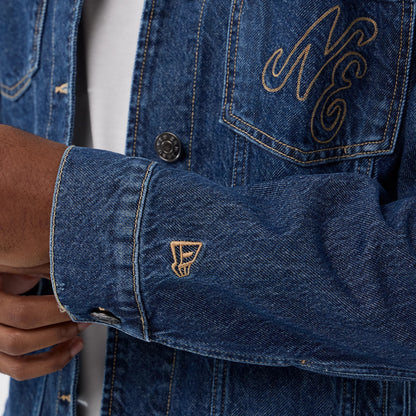 The model is wearing this New Era Script Denim Jacket in dark blue. 7