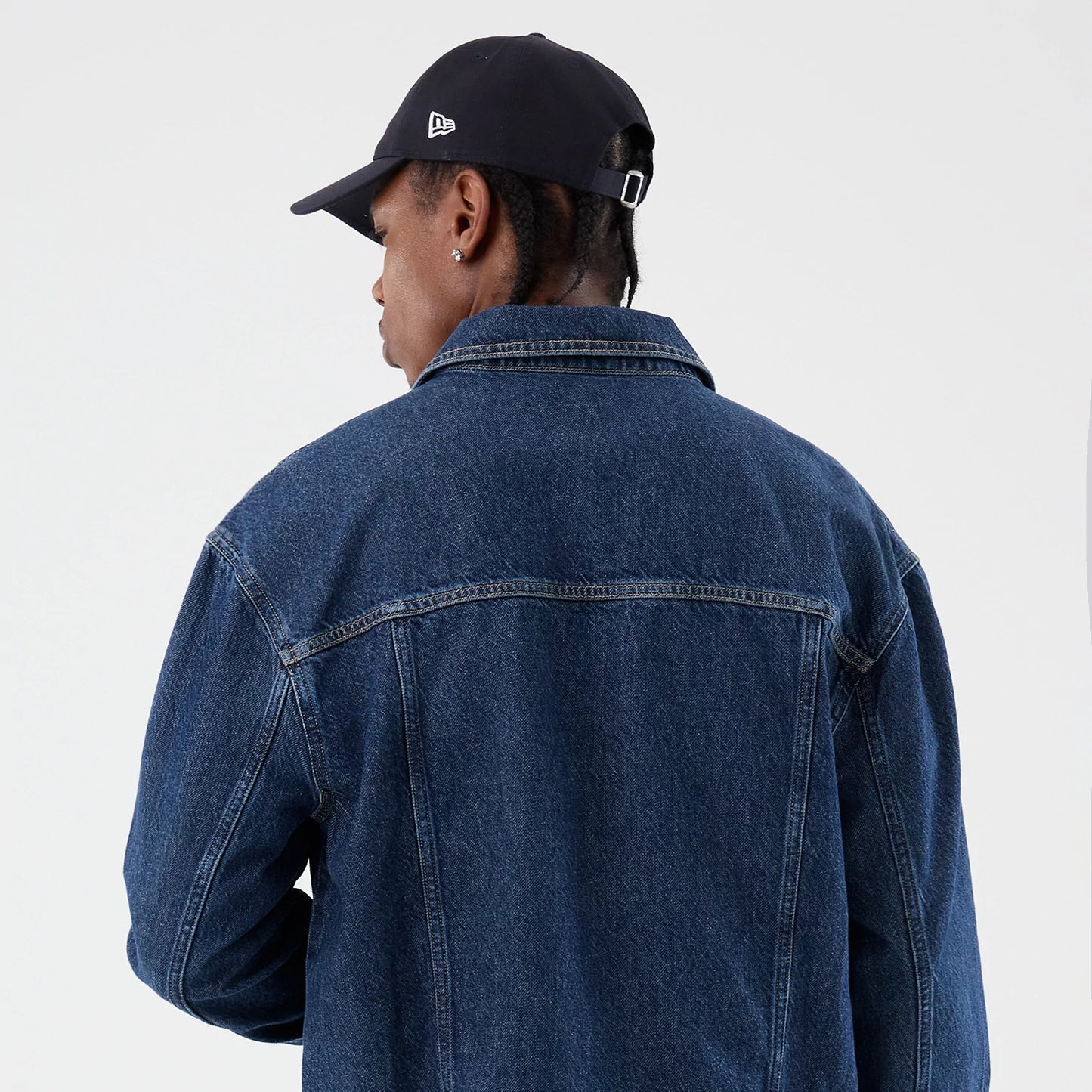 The model is wearing this New Era Script Denim Jacket in dark blue. 8