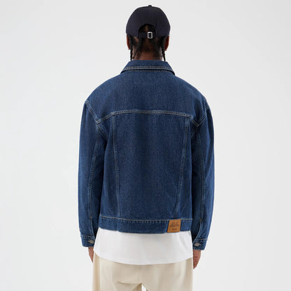 The model is wearing this New Era Script Denim Jacket in dark blue. 2
