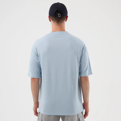 The model is wearing this MLB Script New York Yankees Oversized T-Shirt in pastel blue. 2
