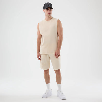 New Era Chicago Bulls NBA Core Plus Light Beige Vest, front view on a model with a matching cap, showing the Bulls logo embossed on the chest, the sleeveless design, and a relaxed fit extending to the waist.