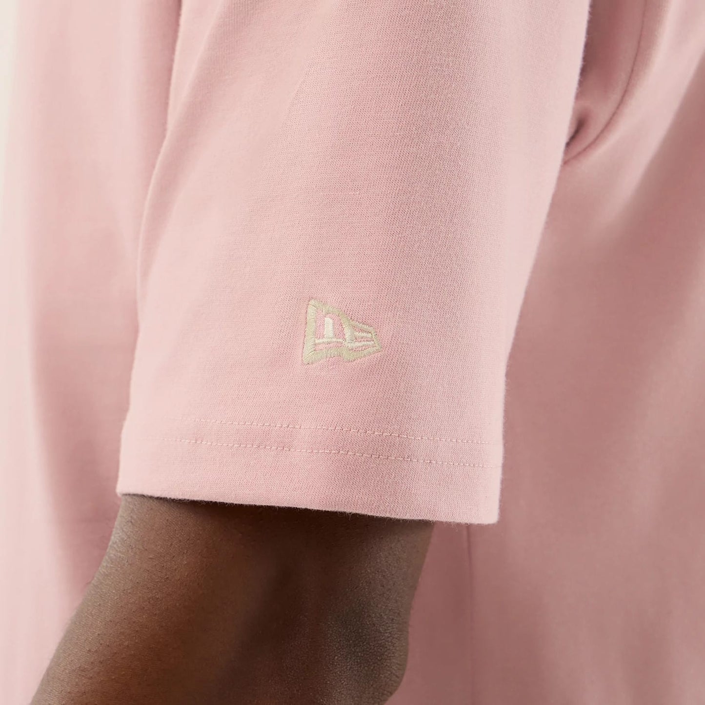 The model is wearing this New Era Floral Graphic Oversized T-Shirt in pastel pink. 7