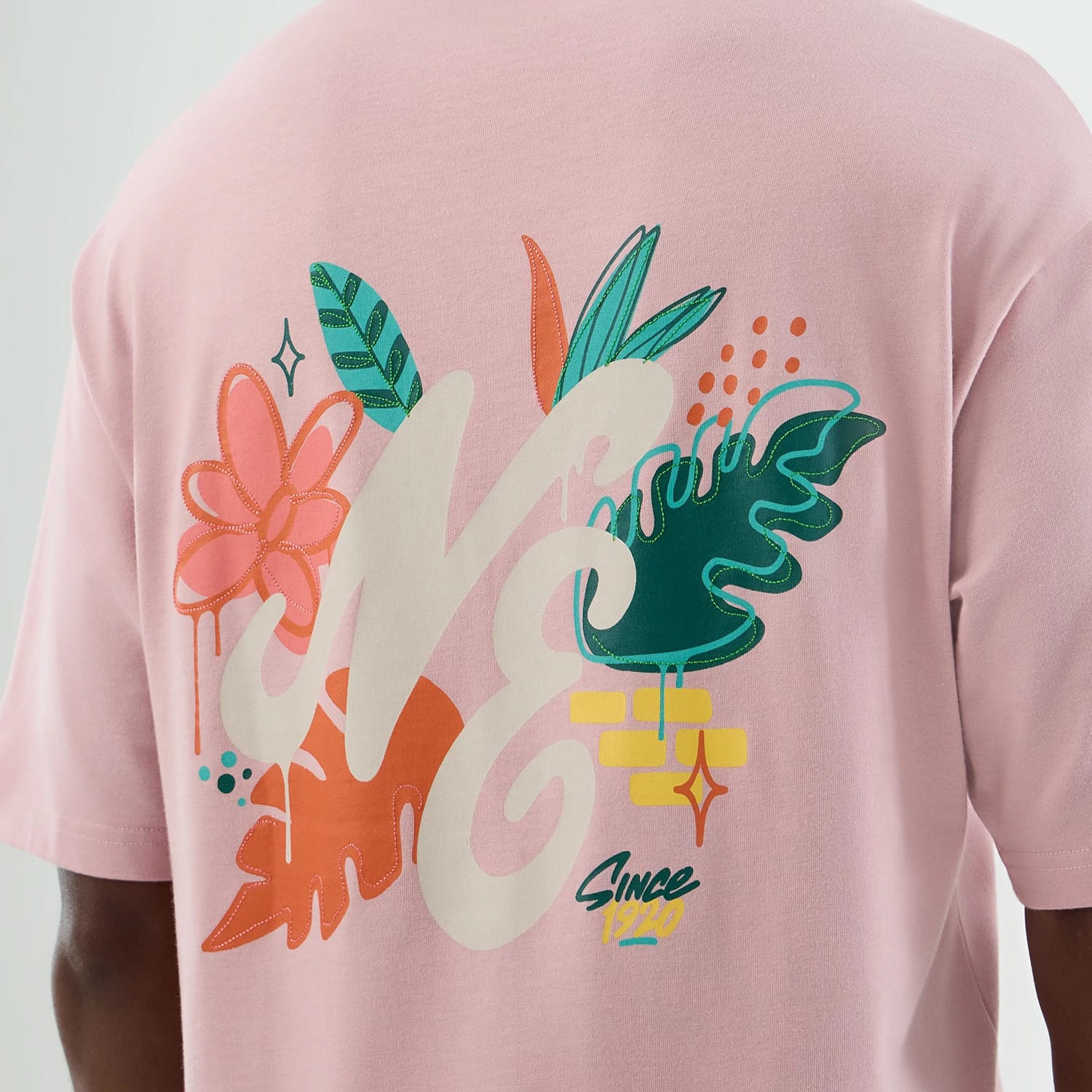 The model is wearing this New Era Floral Graphic Oversized T-Shirt in pastel pink. 8