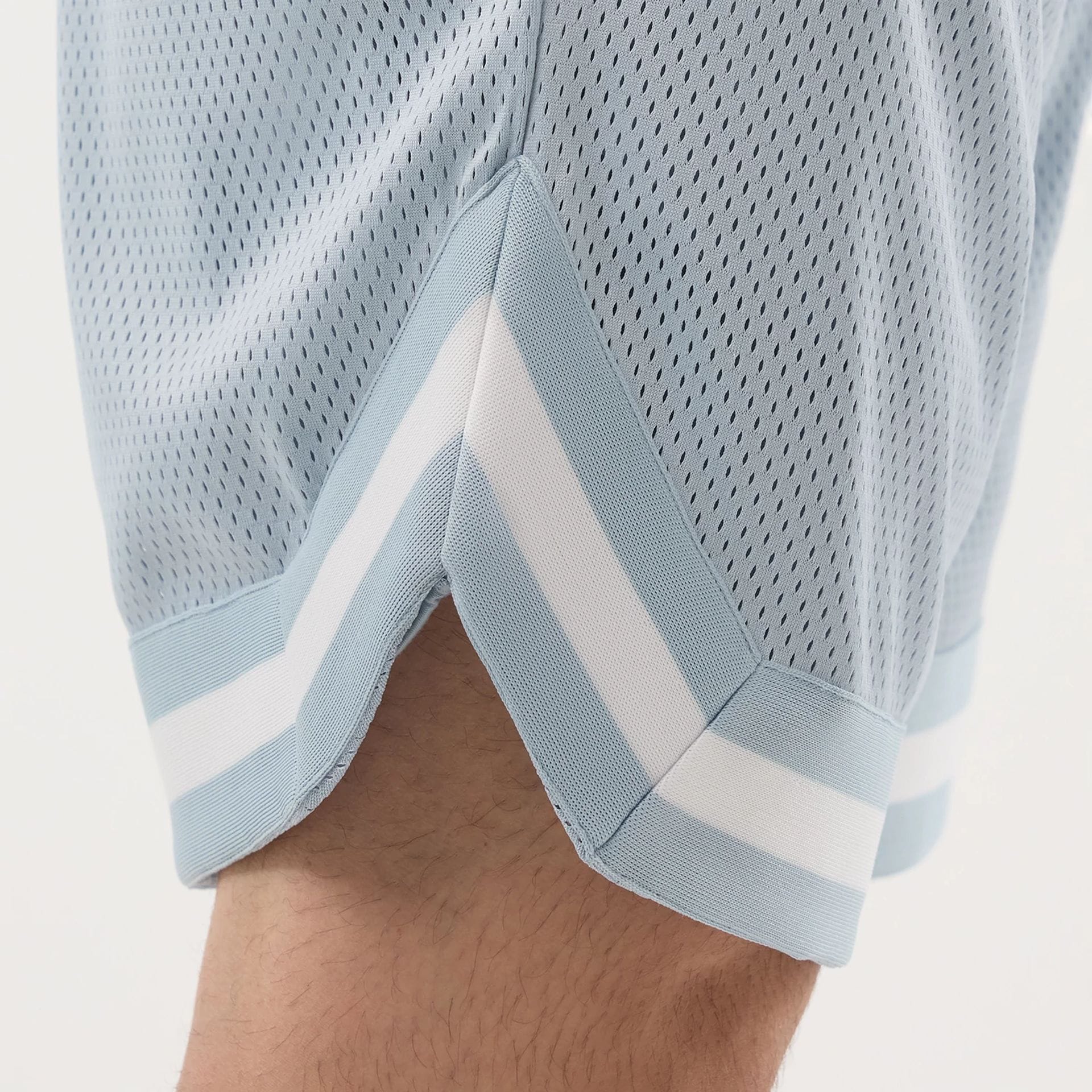 The model is wearing this New Era Mesh Oversized Shorts in pastel blue. 6