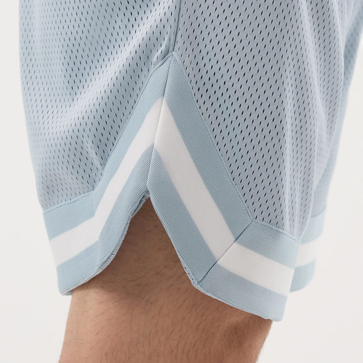 The model is wearing this New Era Mesh Oversized Shorts in pastel blue. 6
