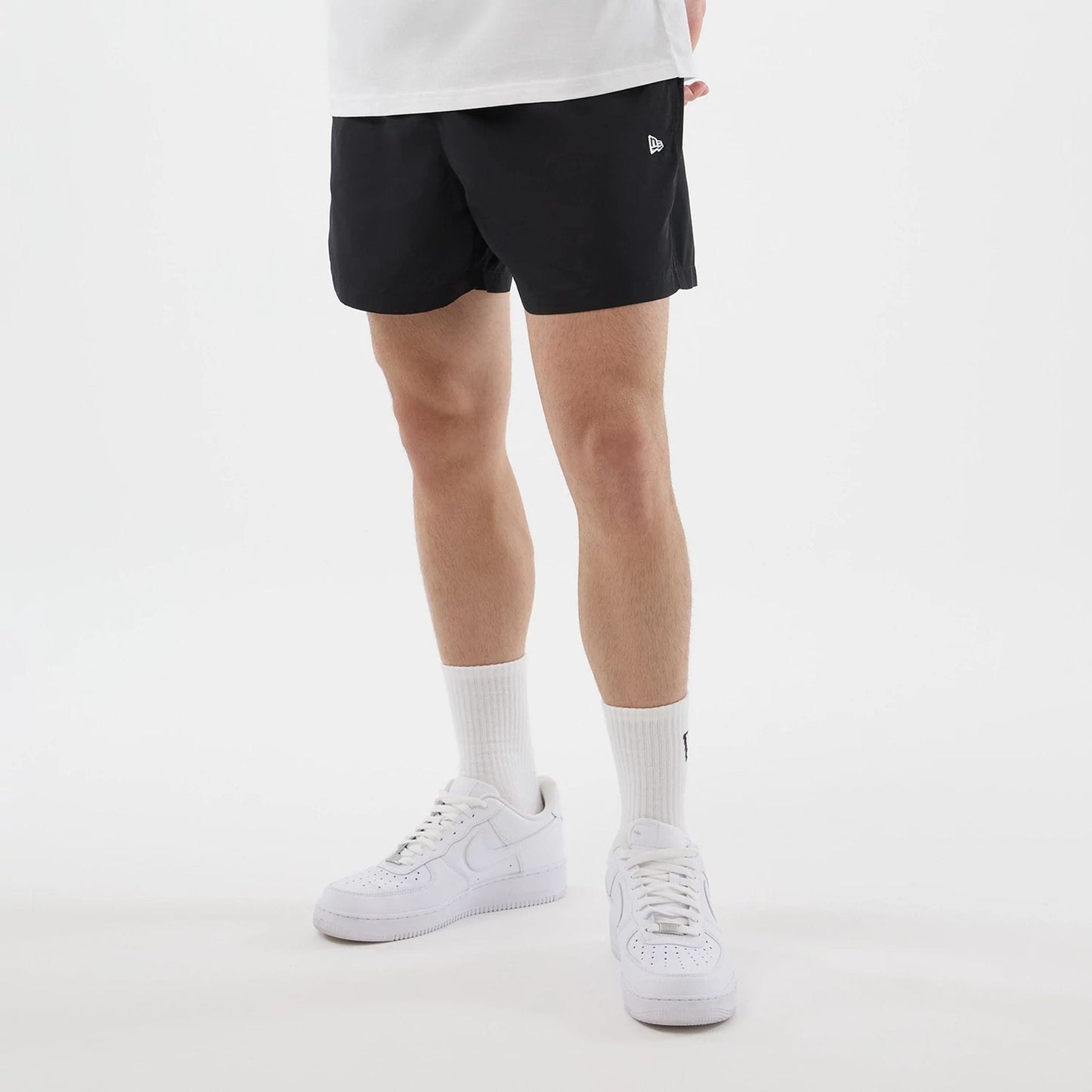 The model is wearing this New Era Swimming Shorts in black. 3