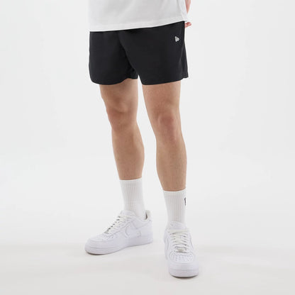 The model is wearing this New Era Swimming Shorts in black. 3