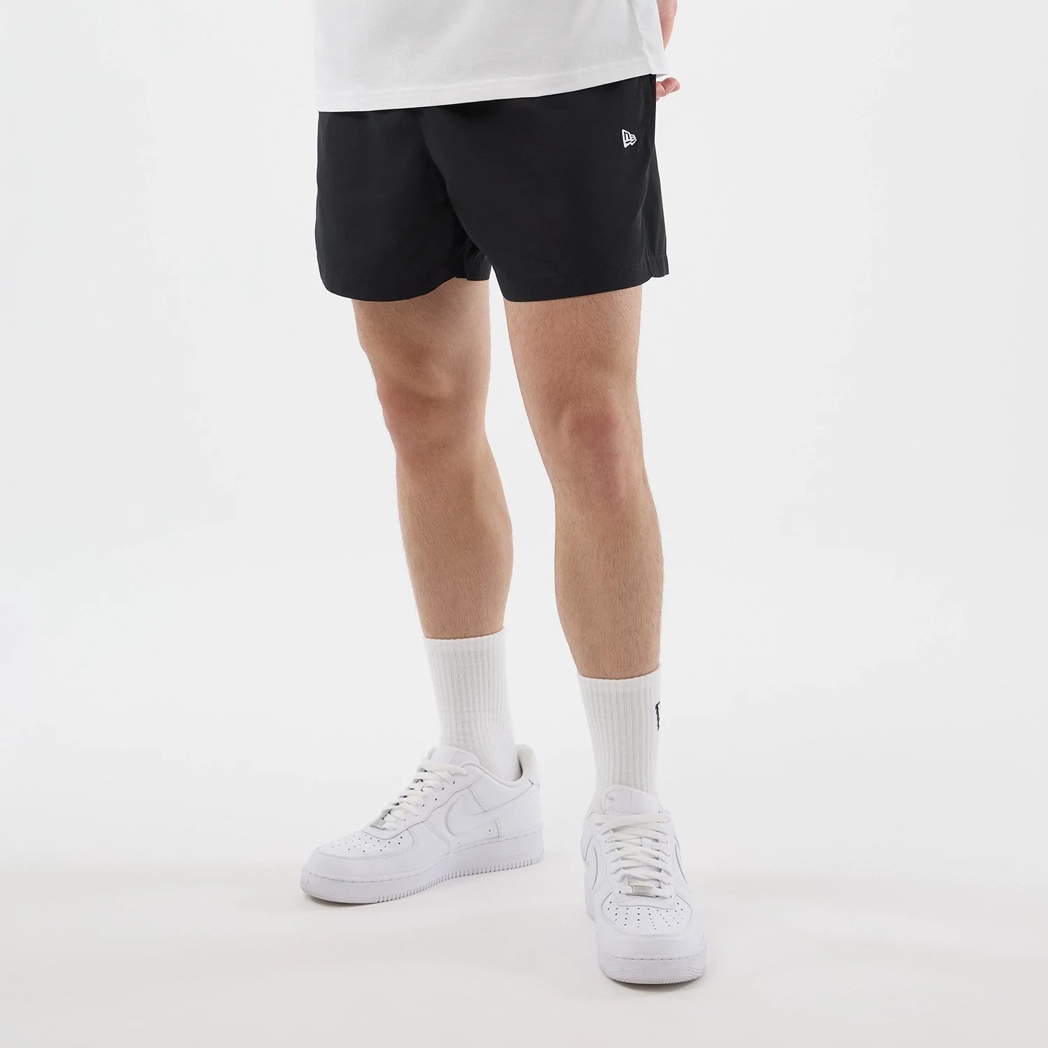 The model is wearing this New Era Swimming Shorts in black. 3