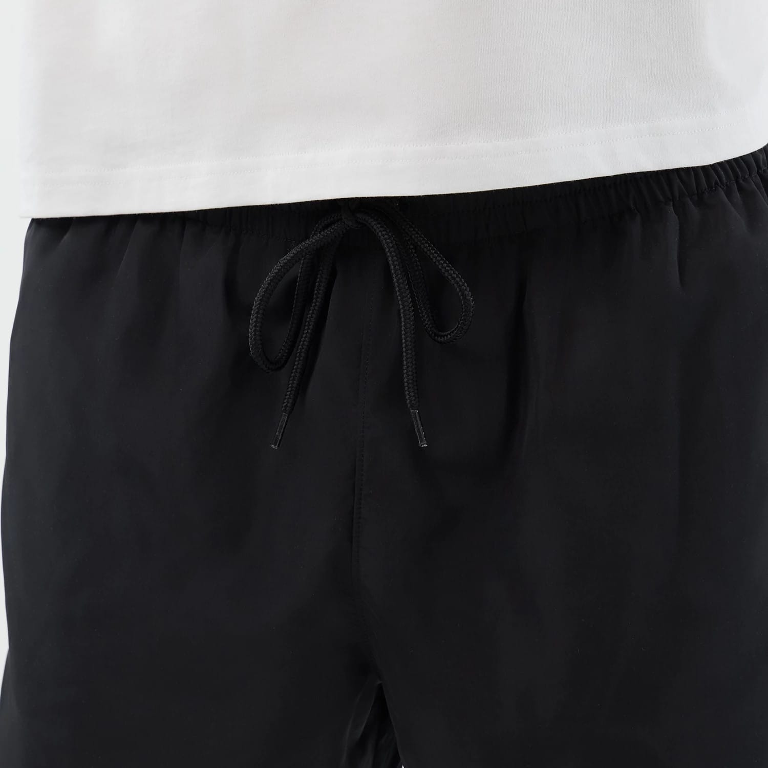 The model is wearing this New Era Swimming Shorts in black. 7