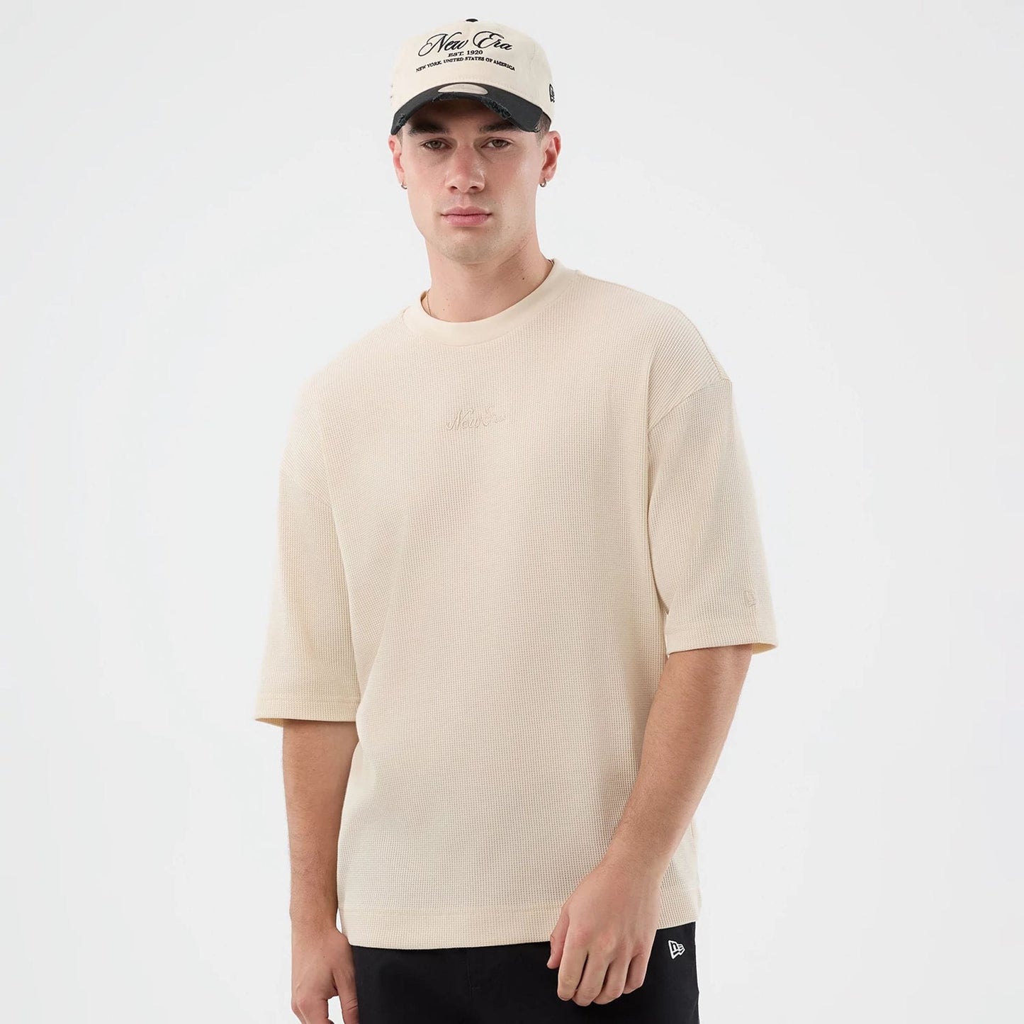 The model is wearing this New Era Waffle T-Shirt in light beige. 3