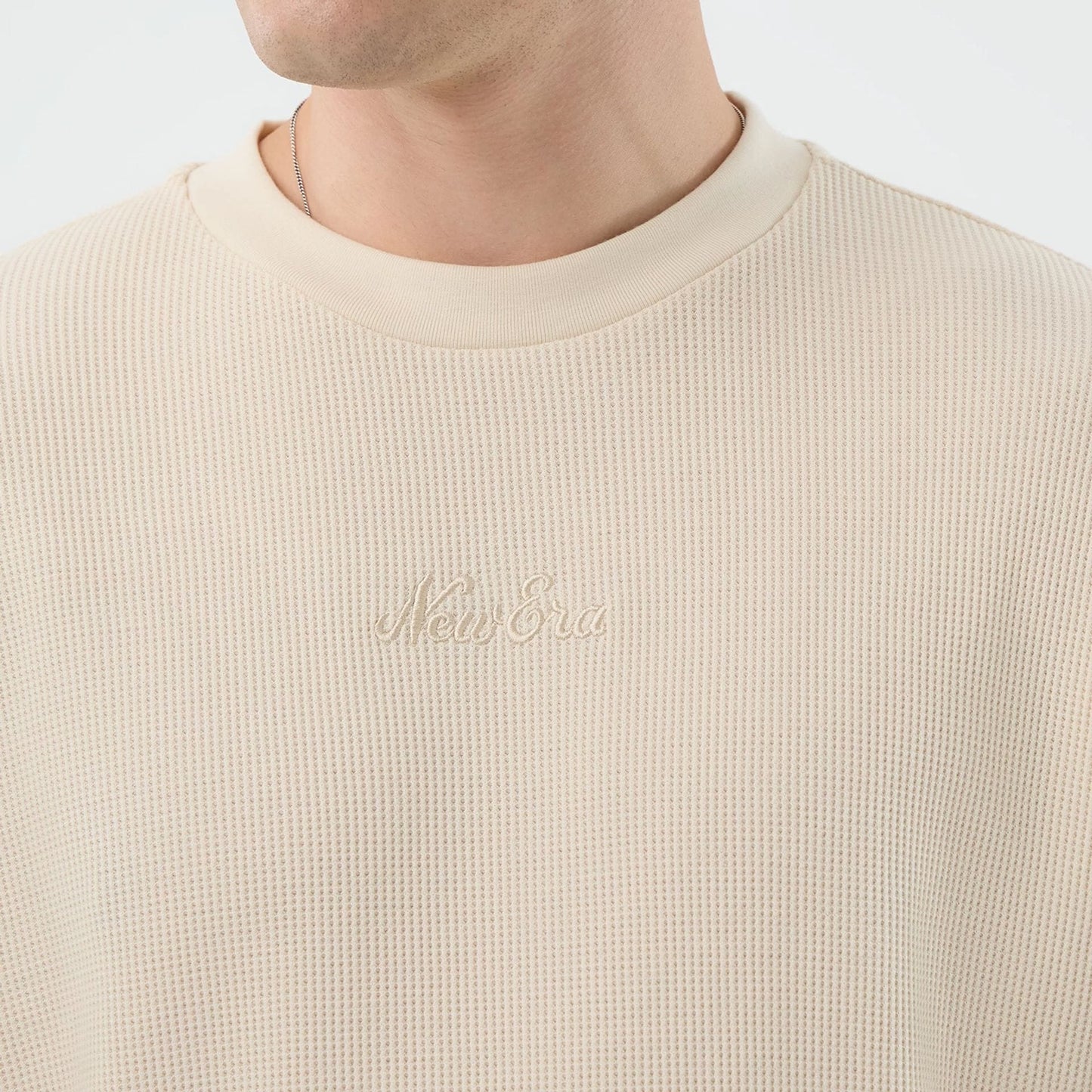 The model is wearing this New Era Waffle T-Shirt in light beige. 5