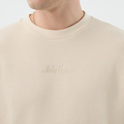 The model is wearing this New Era Waffle T-Shirt in light beige. 5