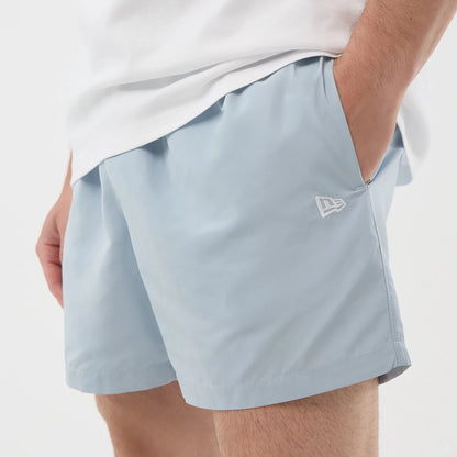 The model is wearing this New Era Swimming Shorts in pastel blue. 4