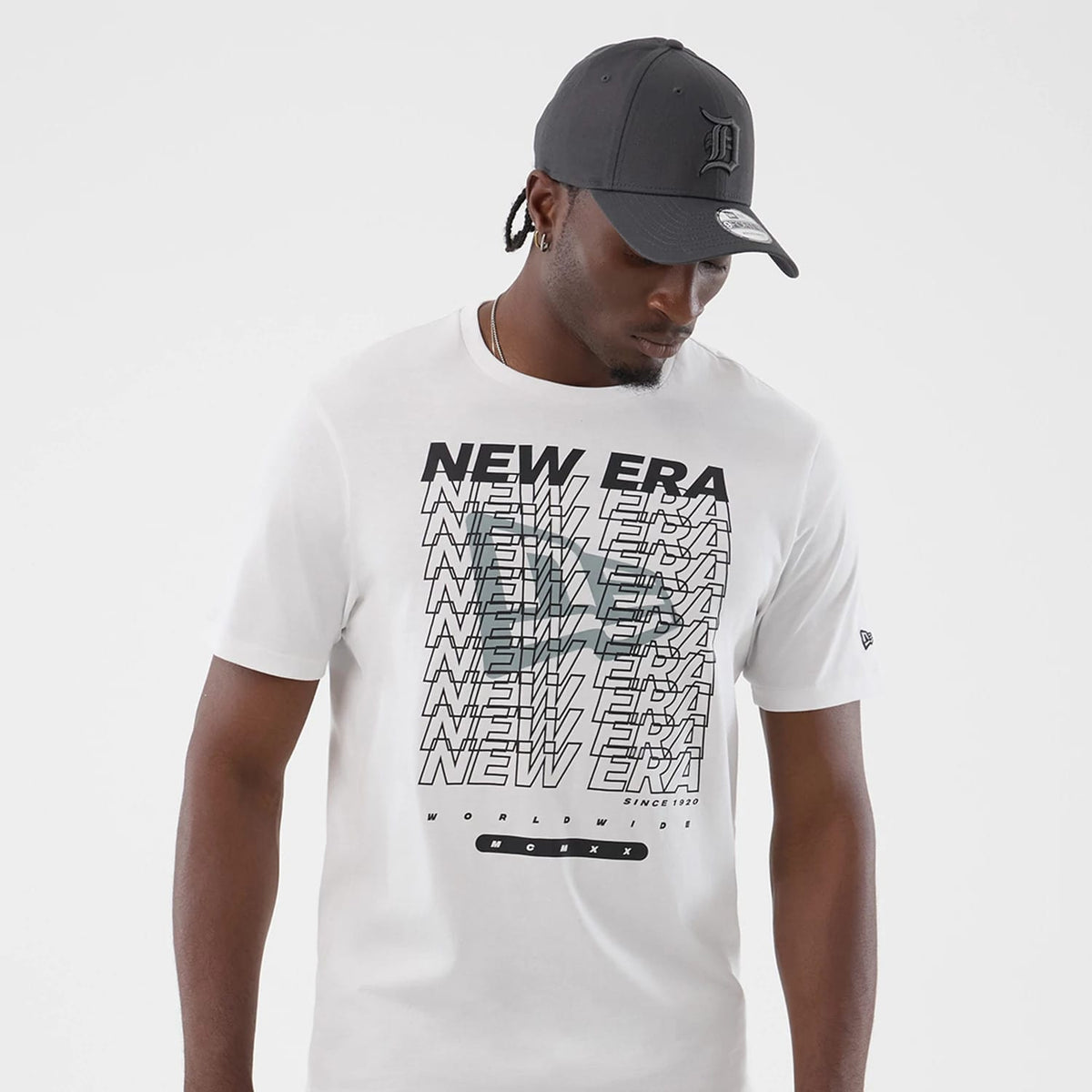 The model is wearing this New Era Logo Graphic T-Shirt in white. 3