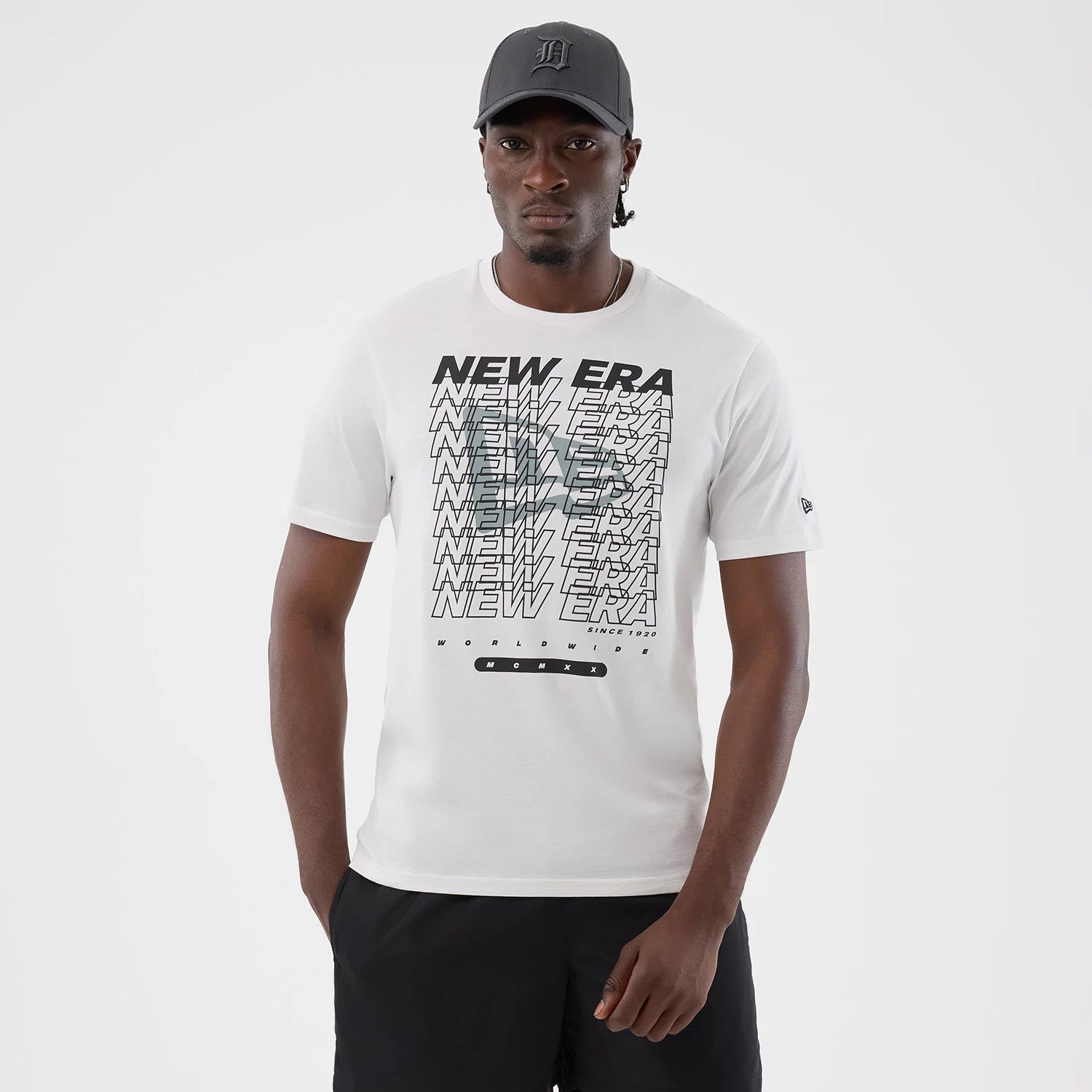 The model is wearing this New Era Logo Graphic T-Shirt in white. 1