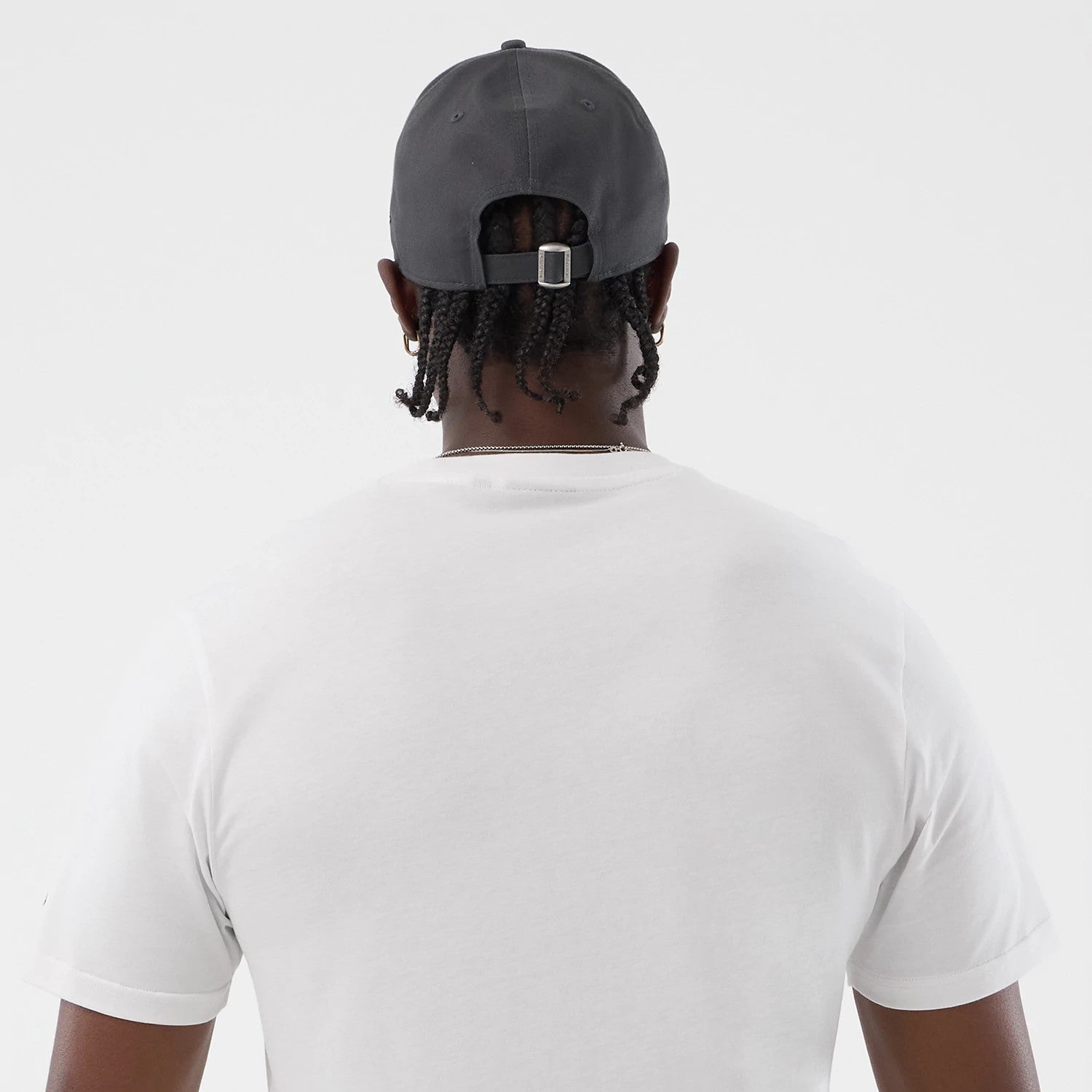 The model is wearing this New Era Logo Graphic T-Shirt in white. 7