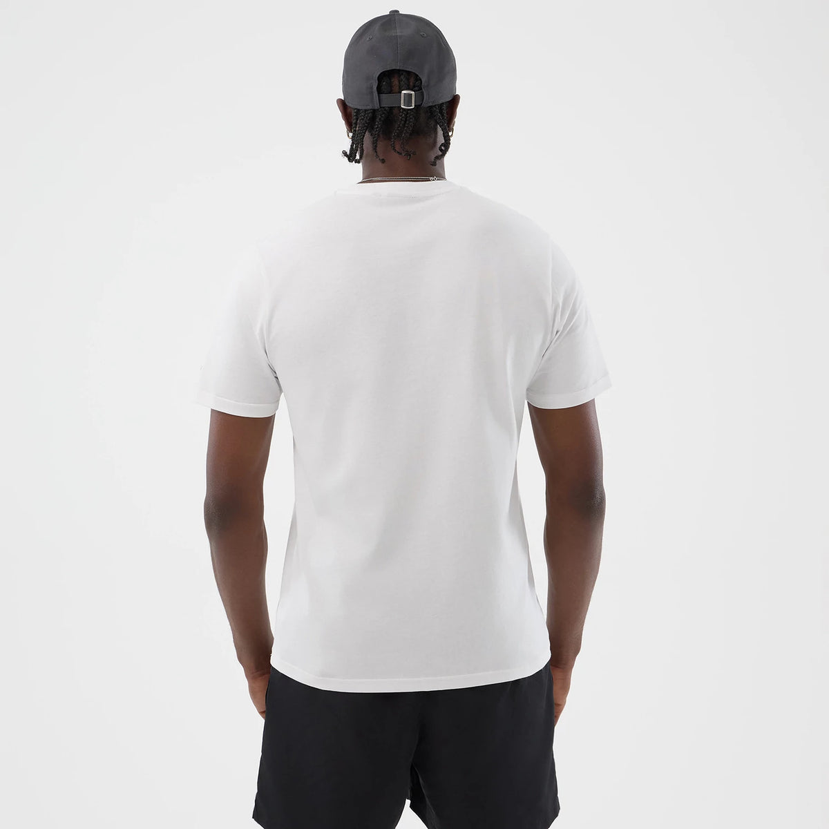 The model is wearing this New Era Logo Graphic T-Shirt in white. 2