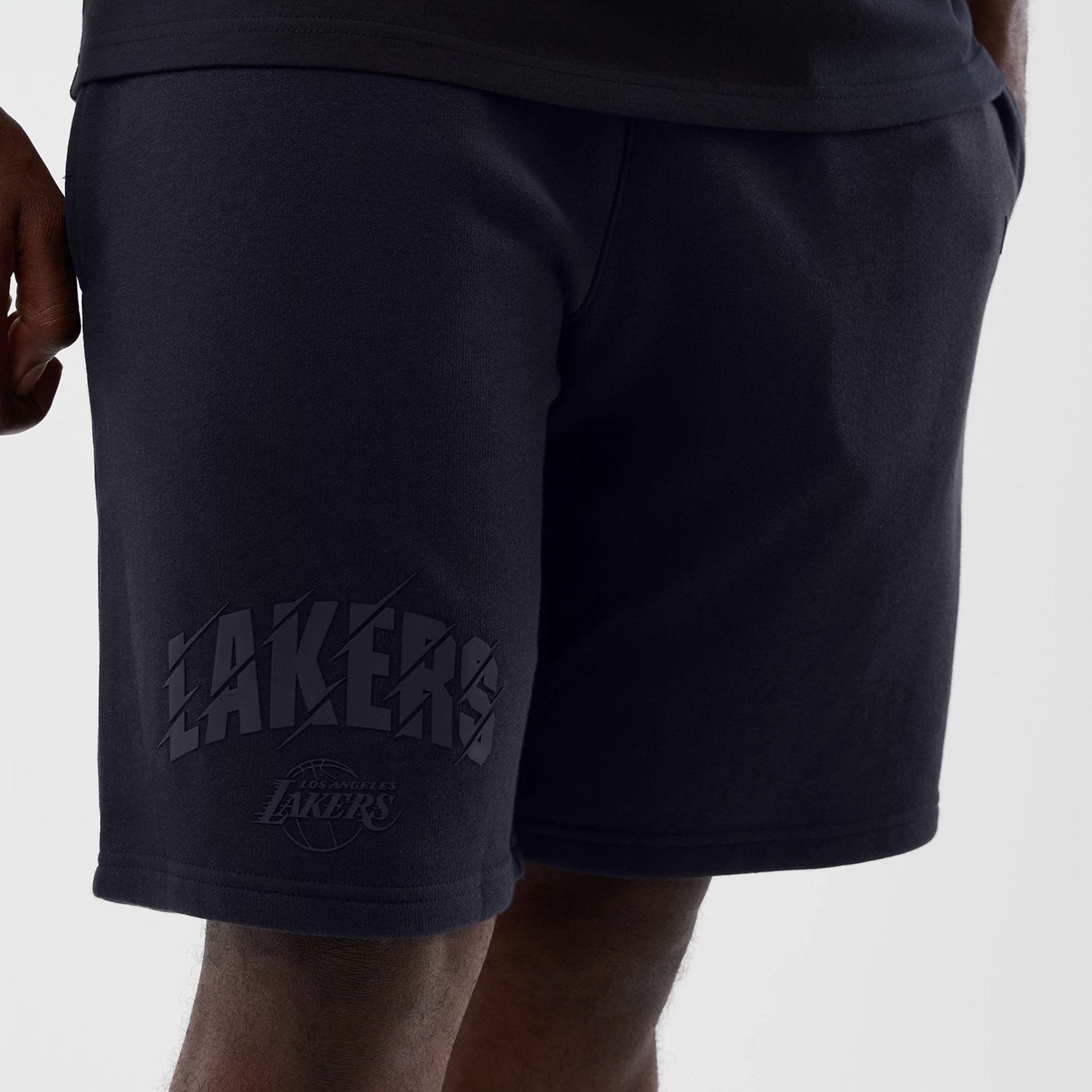 The model is wearing this NBA Core Plus LA Lakers Shorts in navy. 3
