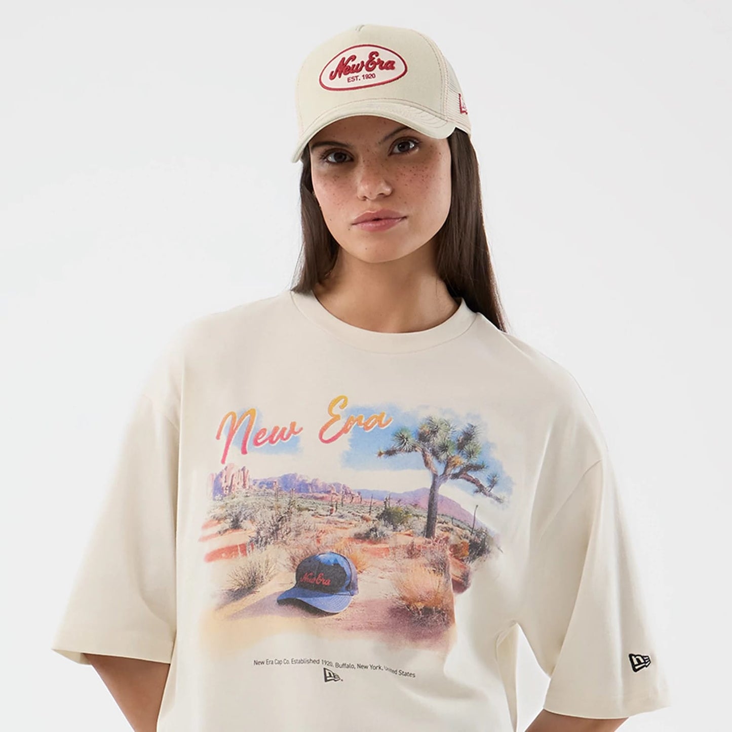 The model is wearing this New Era Dessert Graphic Oversized T-Shirt in light beige. 6