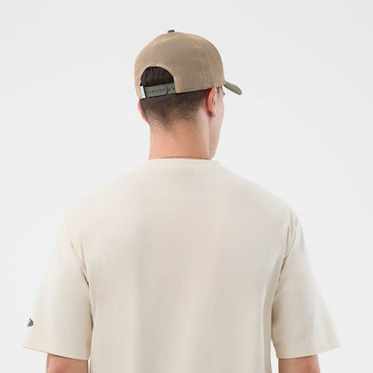 The model is wearing this New Era Dessert Graphic Oversized T-Shirt in light beige. 8