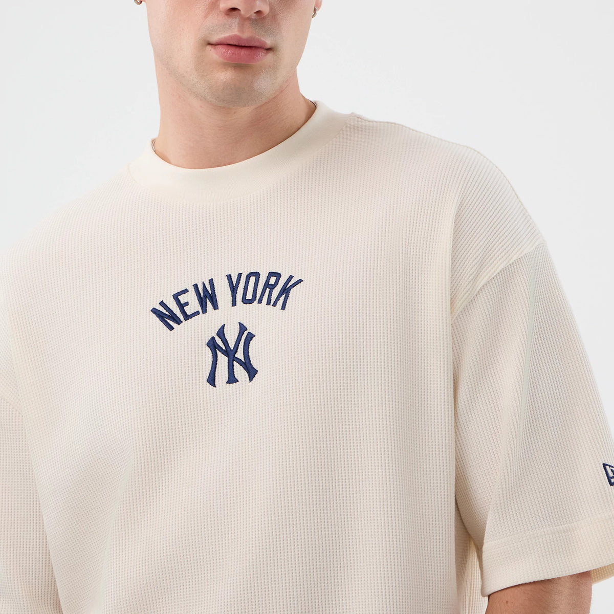 New Era New York Yankees MLB Waffle Open White T-Shirt, front view on a model highlighting the navy embroidered NEW YORK lettering and logo on the chest, with short sleeves and an embroidered logo on the lower left sleeve.