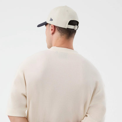 New Era New York Yankees MLB Waffle Open White T-Shirt, back view on a model styled with a cream cap, showcasing the textured waffle knit fabric with loose sleeves, set against a simple neckline and a relaxed oversized fit.