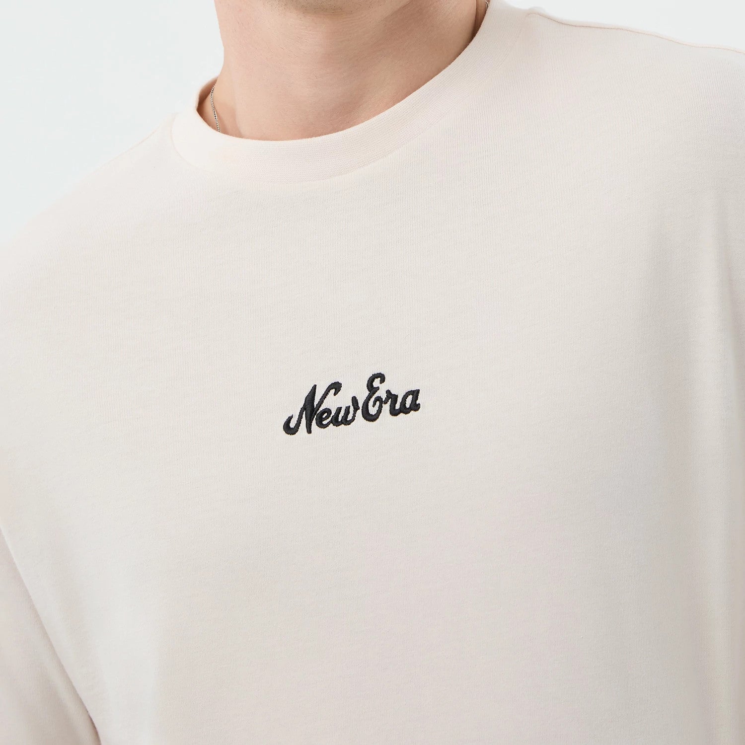 The model is wearing this New Era Floral Graphic Oversized T-Shirt in open white. 4