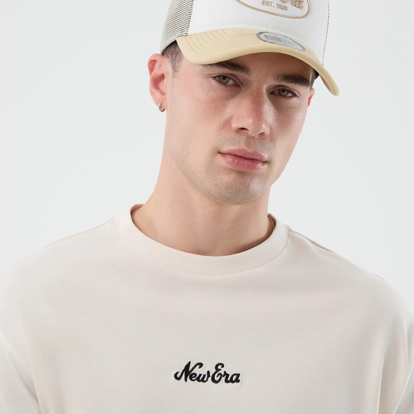 The model is wearing this New Era Floral Graphic Oversized T-Shirt in open white. 6