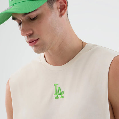 New Era LA Dodgers MLB League Essential Open White Vest, on-model front view showing a vivid green LA logo in raised embroidery on the chest of the sleeveless white vest, highlighting the simple round neckline and clean armholes.