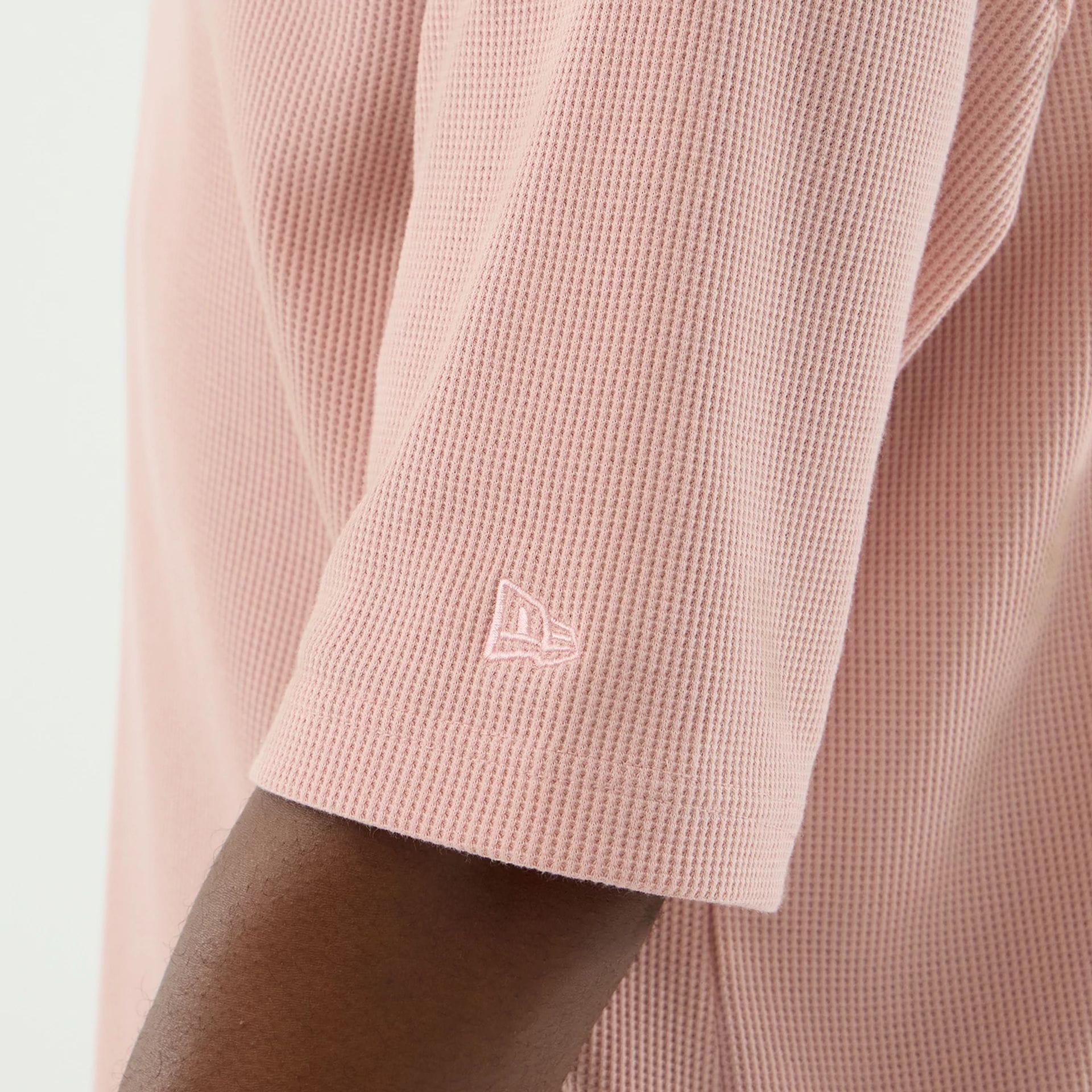 The model is wearing this New Era Waffle T-Shirt in pastel pink. 7