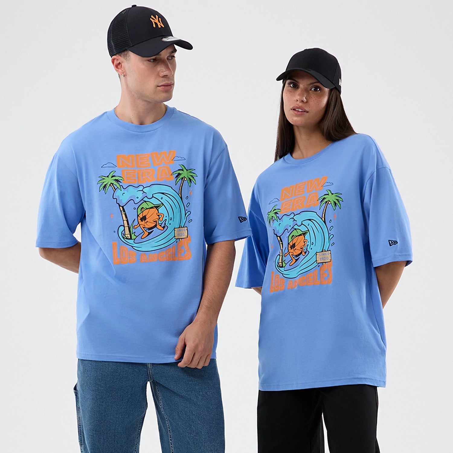 The model is wearing this New Era Basketball Character Graphic T-Shirt in pastel blue. 1