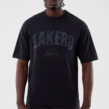 New Era LA Lakers NBA Core Plus Navy Oversized T-Shirt, front view showing raised Lakers lettering across the chest with a smaller Los Angeles Lakers logo beneath, worn by a model with short sleeves and a round neckline.