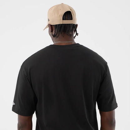 The model is wearing this New Era Serpent Graphic Oversized T-Shirt in black. 7
