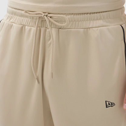 The model is wearing these New Era Football Shorts in light beige. 5