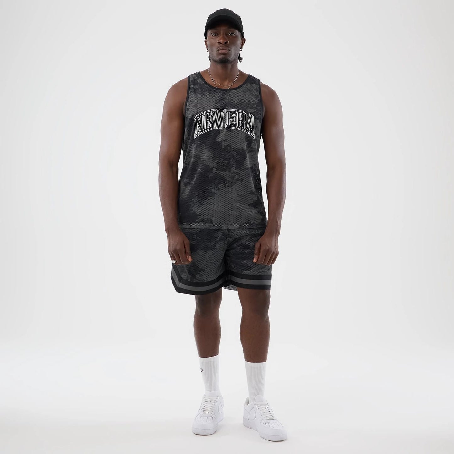 The model is wearing this New Era All Over Print Mesh Shorts in black camo. 7