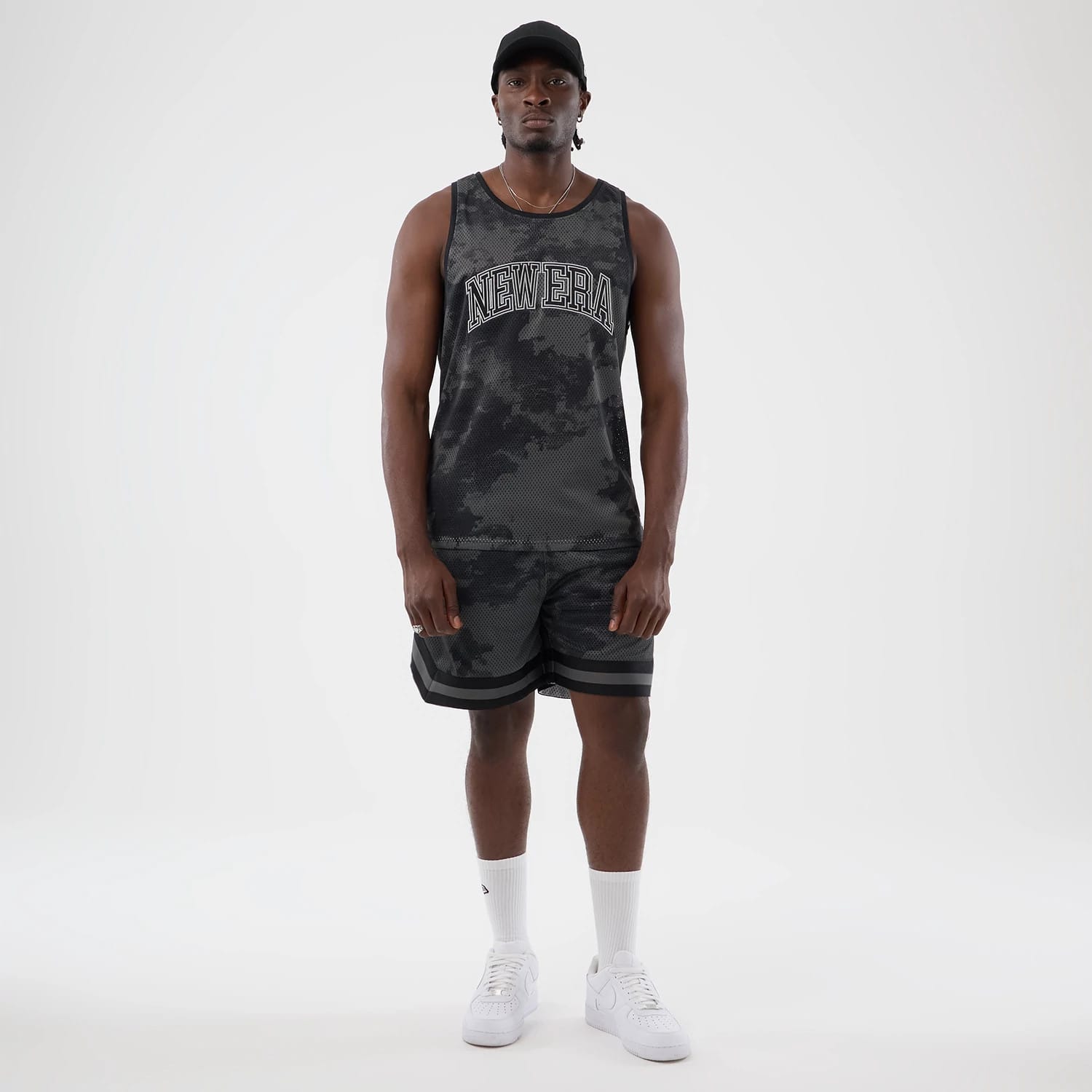 The model is wearing this New Era All Over Print Mesh Shorts in black camo. 7