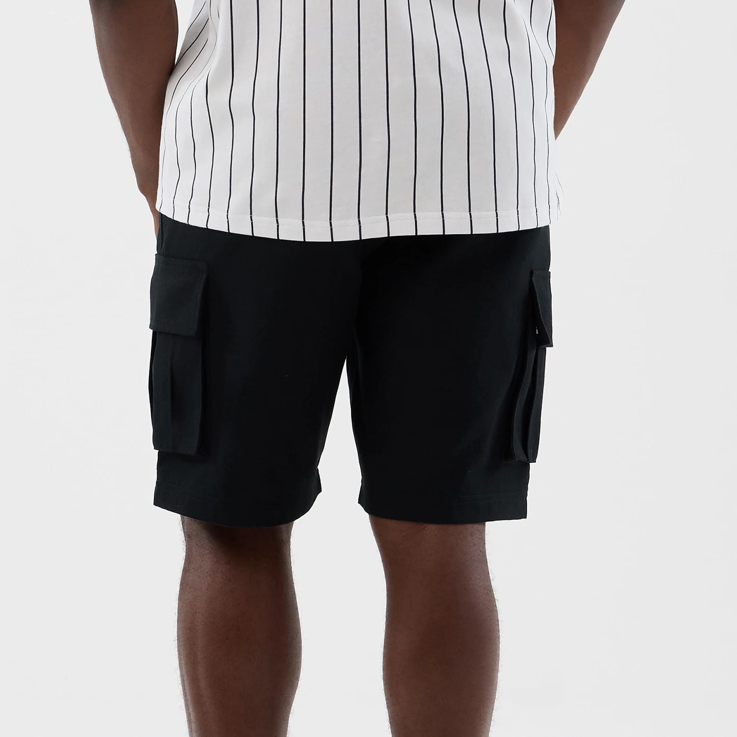 The model is wearing this New Era Cargo Shorts in black. 7