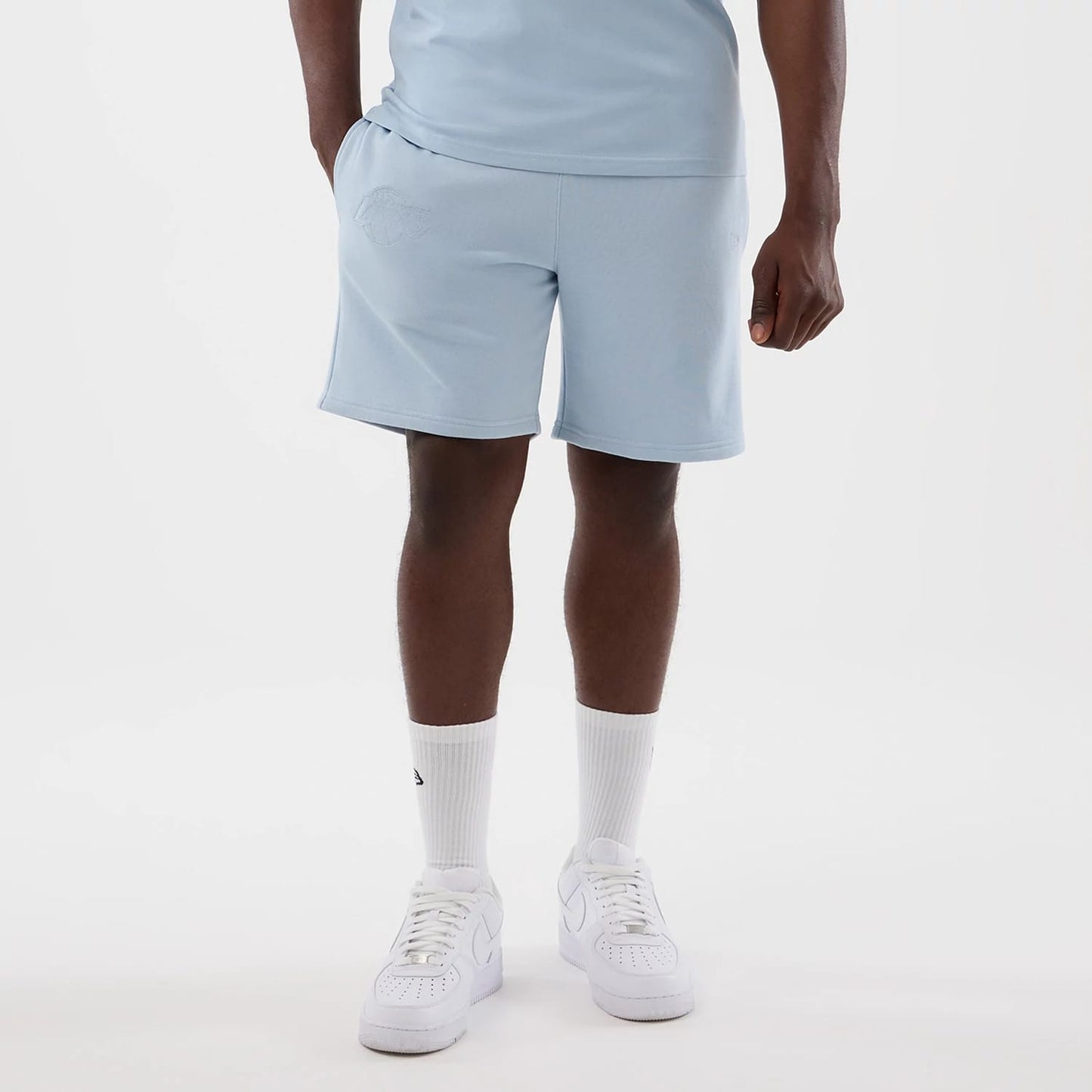 The model is wearing this NBA League Essential LA Lakers Shorts in pastel blue. 7