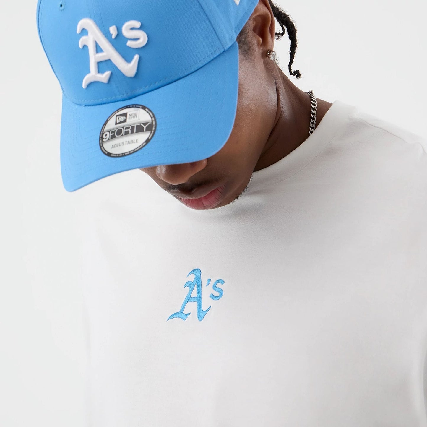 The model is wearing this MLB League Essential Athletics Oversized T-Shirt in white. 5
