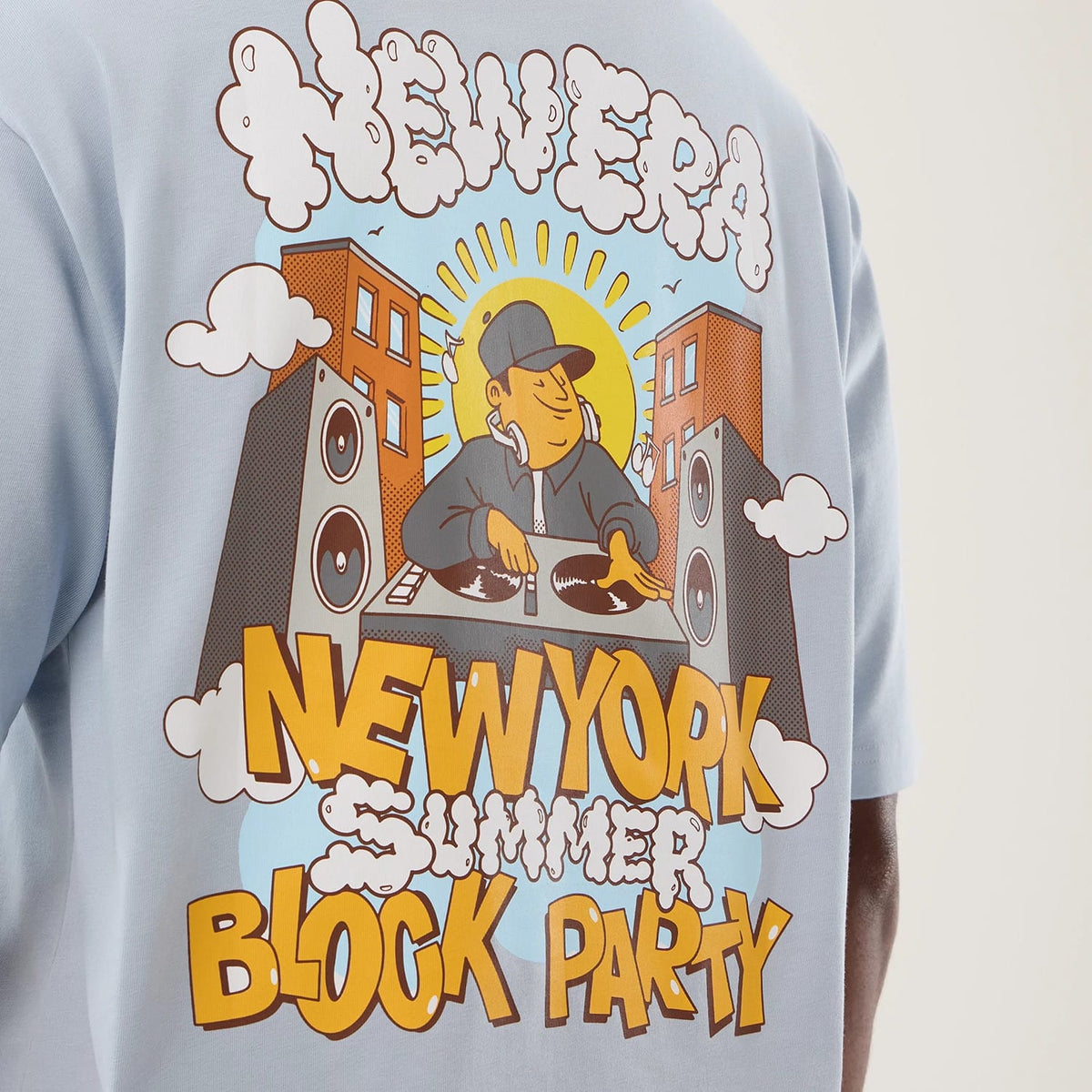 The model is wearing this New Era Fun Block Party Graphic Oversized T-Shirt in pastel blue. 8