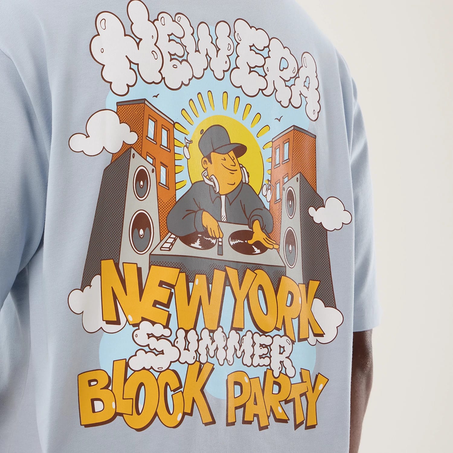 The model is wearing this New Era Fun Block Party Graphic Oversized T-Shirt in pastel blue. 8