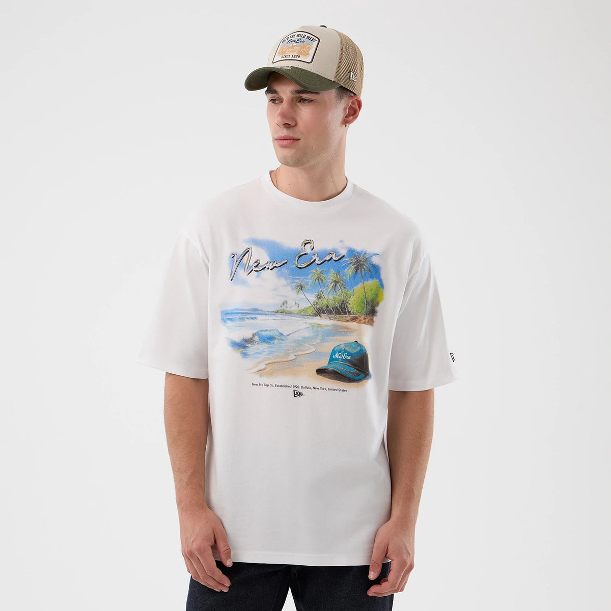 The model is wearing this New Era Beach Graphic Oversized T-Shirt in white. 3