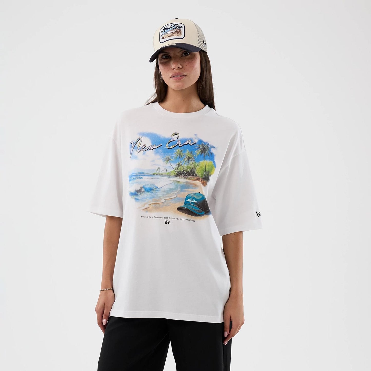 The model is wearing this New Era Beach Graphic Oversized T-Shirt in white. 4
