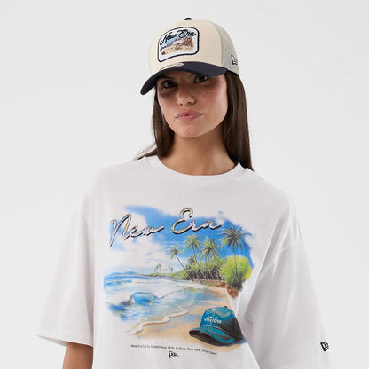 The model is wearing this New Era Beach Graphic Oversized T-Shirt in white. 6